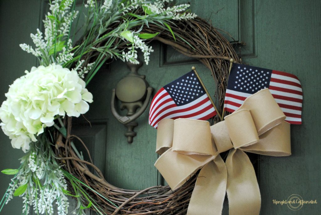 This DIY Spring Wreath easily transitioned to a beautiful simmer wreath with the addition of a burlap bow and a couple of American flags. 