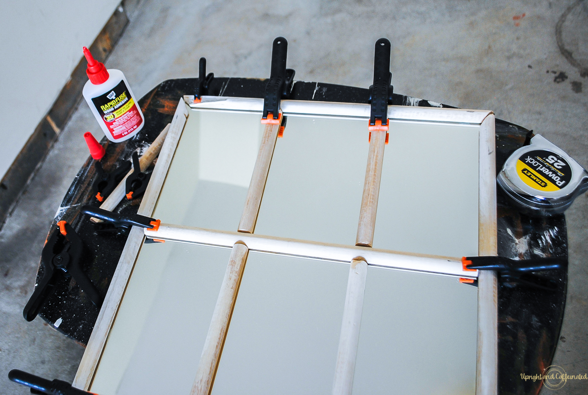 I used clamps to hold the trim in place to make this farmhouse window mirror. 