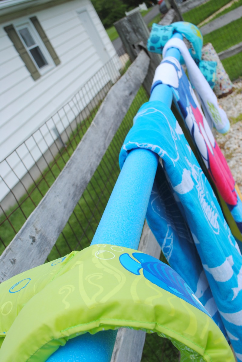 Make this outdoor towel rack with galvanized pipe and a couple of pool noodles!