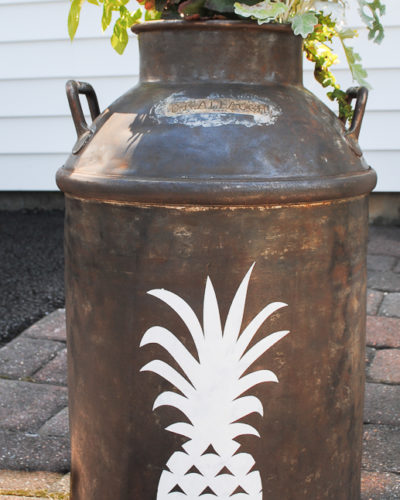 This Pineapple milk can planter brightens any outdoor space with the welcoming pineapple symbol.