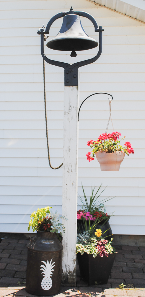 Greet guests with a welcoming pineapple milk can planter. 