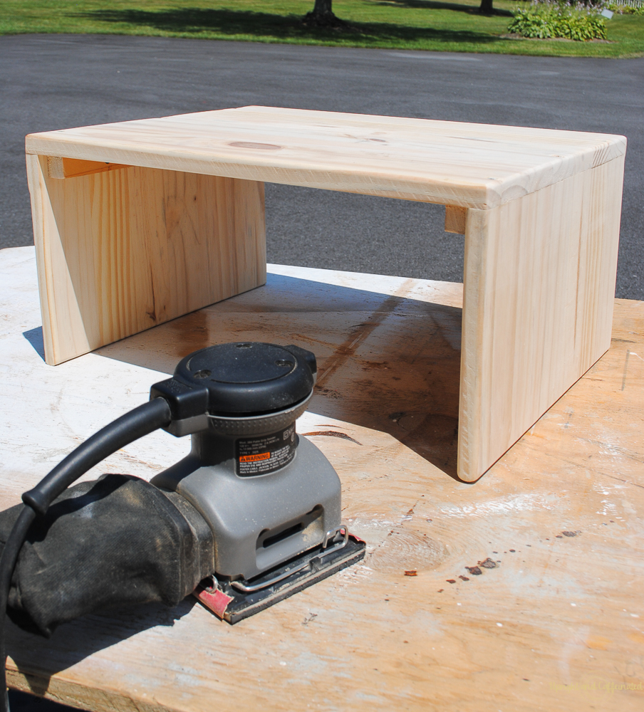 Use a sander to smooth out the wood on this DIY laptop table. 