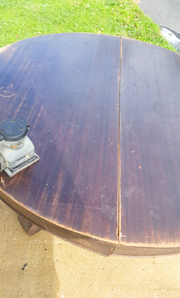 Sanding this round dining table was a great way to remove the old finish. 