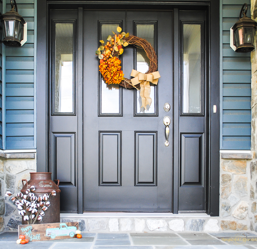 This front door is so welcoming with the beautiful fall wreath and fall sign. 